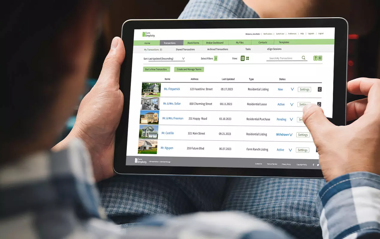 Man looking at real estate listings on tablet