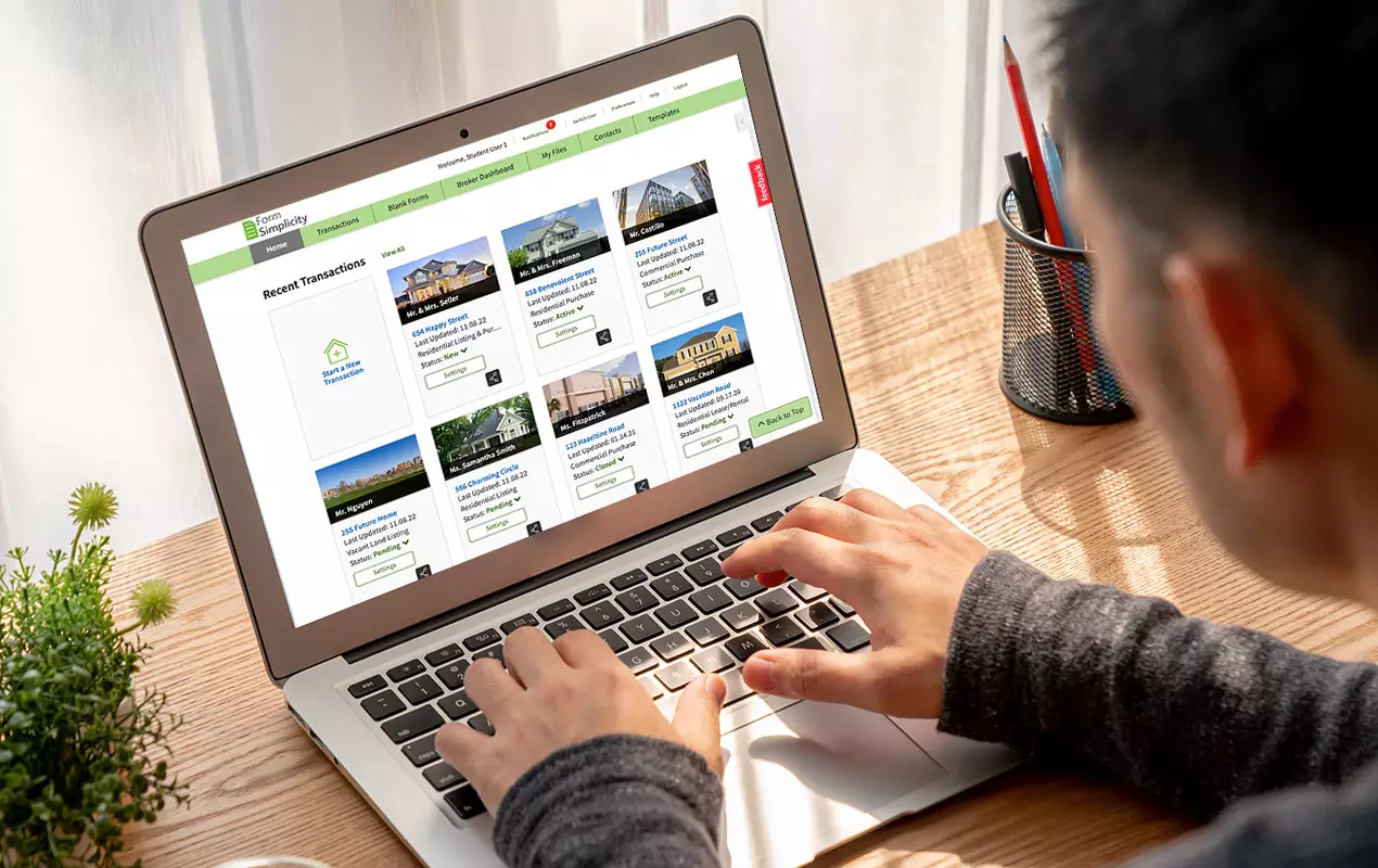 Man looking at real estate listings on laptop