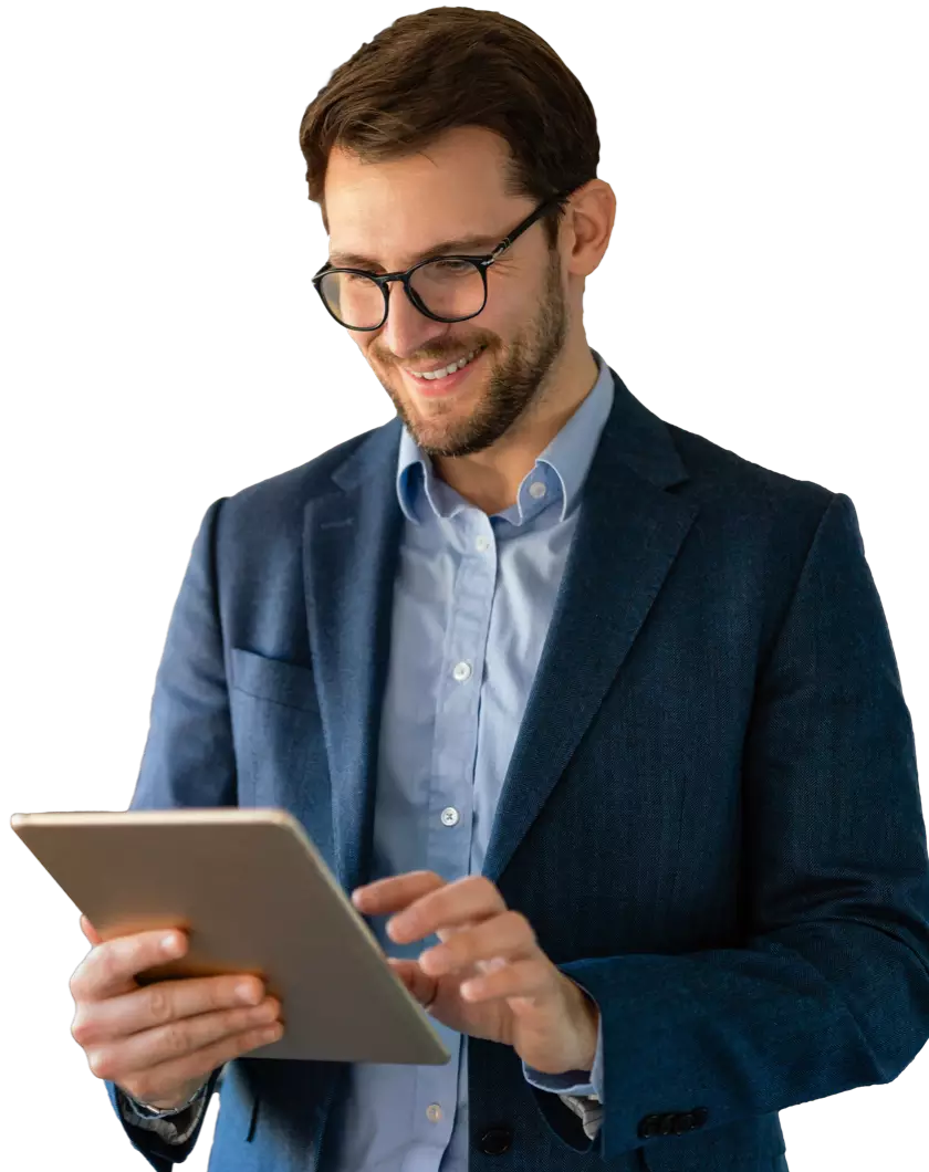 Man in suit smiling and using tablet