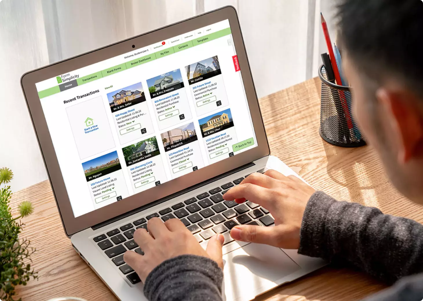 Man looking at real estate listings on laptop