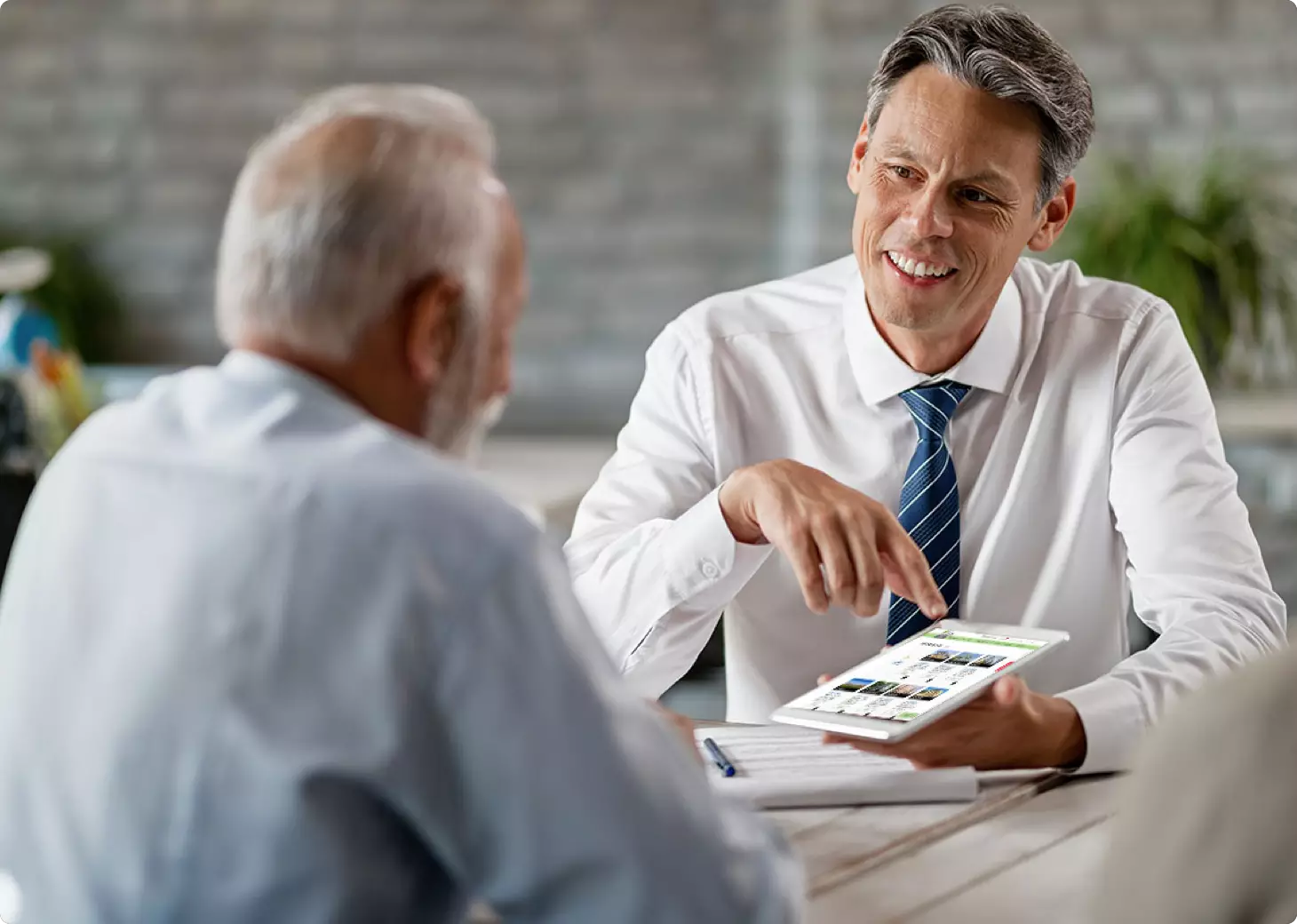 Agent and customer looking at tablet