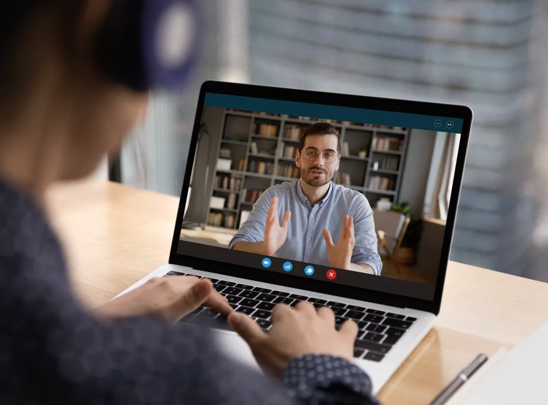 Man in video meeting on laptop
